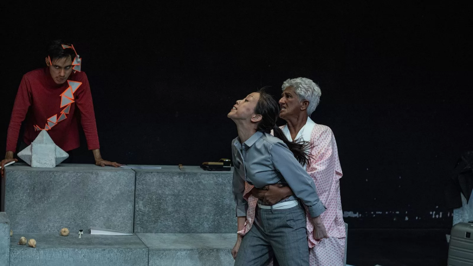 Anne James holds Sandee Chew back as Engku Armand stares ominously in the background in this scene from POLY